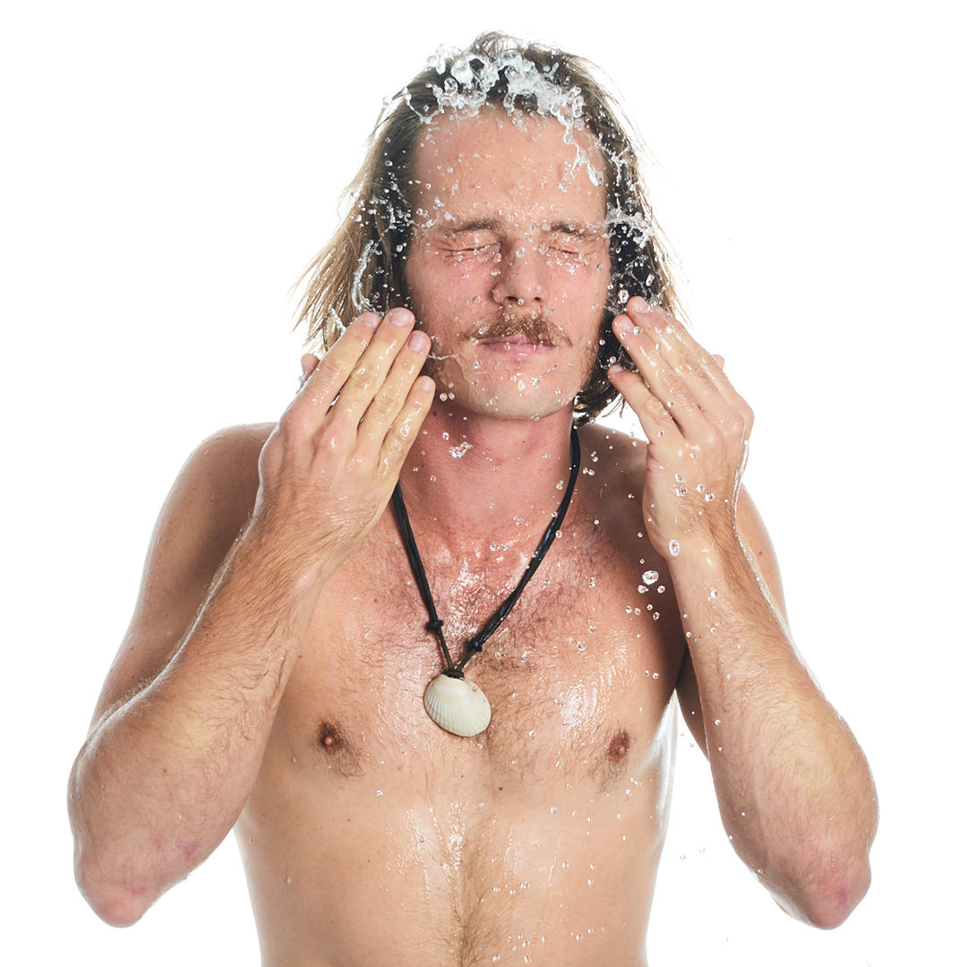Man splashing water on his face